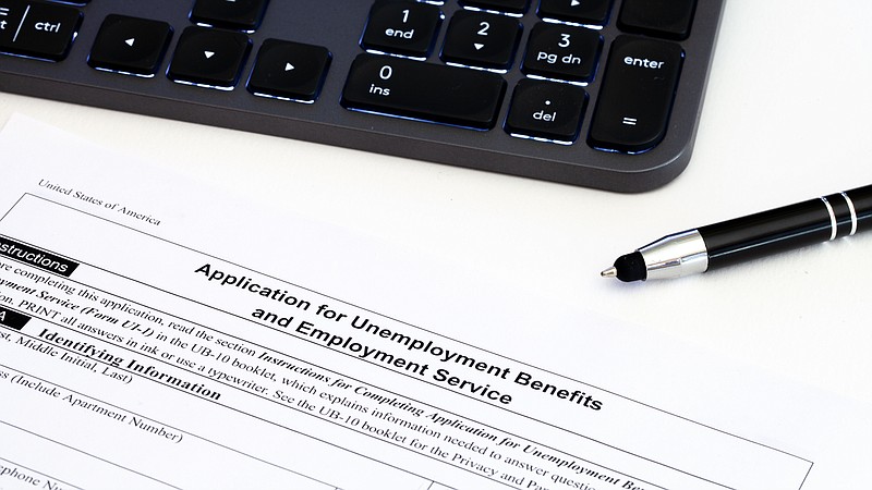 Application for employment benefits form with computer keyboard and pen on white background. Unemployment rate has risen sharply in United States due to closed business caused by corona virus outbreak - stock photo unemployment tile jobs tile 
