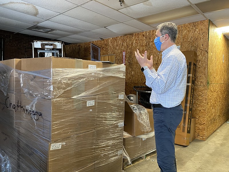Contributed photo / Chattanooga Mayor Andy Berke stands beside boxes holding a shipment of 20,000 face masks that he requested from the state to help protect citizens as local COVID-19 cases and hospitalizations continue to climb.