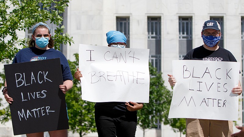 Staff photo by C.B. Schmelter / People hold signs during a protest against the killing of George Floyd at Miller Park on Saturday, May 30, 2020 in Chattanooga, Tenn. Floyd, 46, died after being handcuffed and pinned for several minutes beneath Minneapolis police Officer Derek Chauvin's knee.