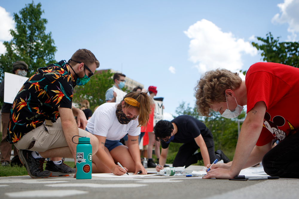 Staff photo by C.B. Schmelter / People make signs during a gathering to protest the killing of George Floyd at Miller Park on Saturday, May 30, 2020 in Chattanooga, Tenn. Floyd, 46, died after being handcuffed and pinned for several minutes beneath Minneapolis police Officer Derek Chauvin's knee.