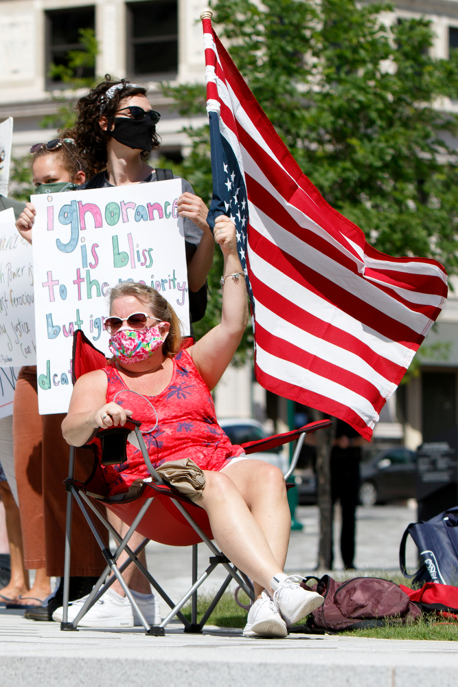 Staff photo by C.B. Schmelter / A person flies an American flag upside down during a protest the killing of George Floyd at Miller Park on Saturday, May 30, 2020 in Chattanooga, Tenn. Floyd, 46, died after being handcuffed and pinned for several minutes beneath Minneapolis police Officer Derek Chauvin's knee.