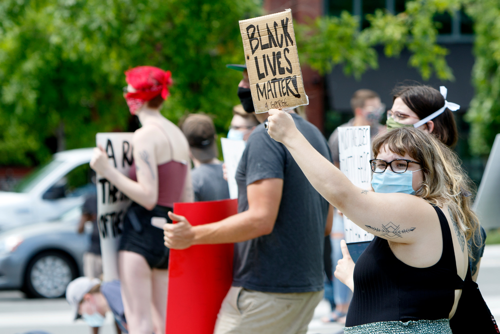 Staff photo by C.B. Schmelter / A protestor holds a Black Lives Matter sign during a protest against the killing of George Floyd at Miller Park on Saturday, May 30, 2020 in Chattanooga, Tenn. Floyd, 46, died after being handcuffed and pinned for several minutes beneath Minneapolis police Officer Derek Chauvin's knee.