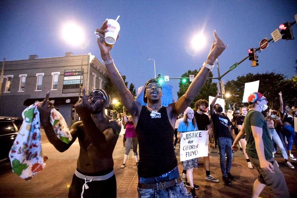 Staff photo by Troy Stolt / Protesters marching over the murder of George Floyd by Minneapolis police officers walk down Frazier Avenue as they chant on Saturday night.
