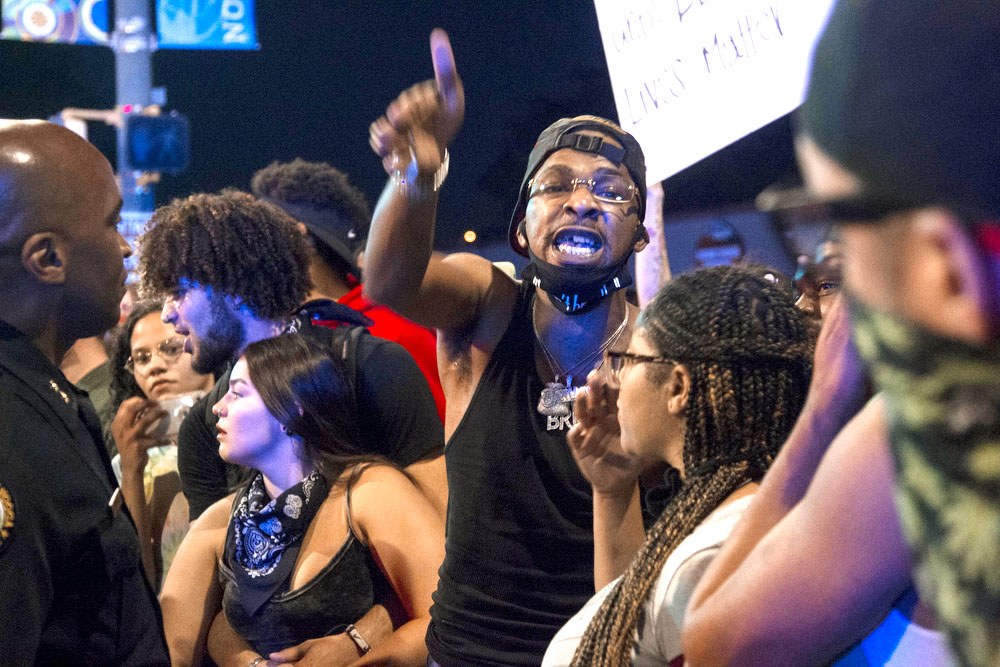 Staff photo by Troy Stolt / A protester engages with Chattanooga Police, Saturday night, on Tremont Street during protests over the murder of George Floyd by Minneapolis police officers.