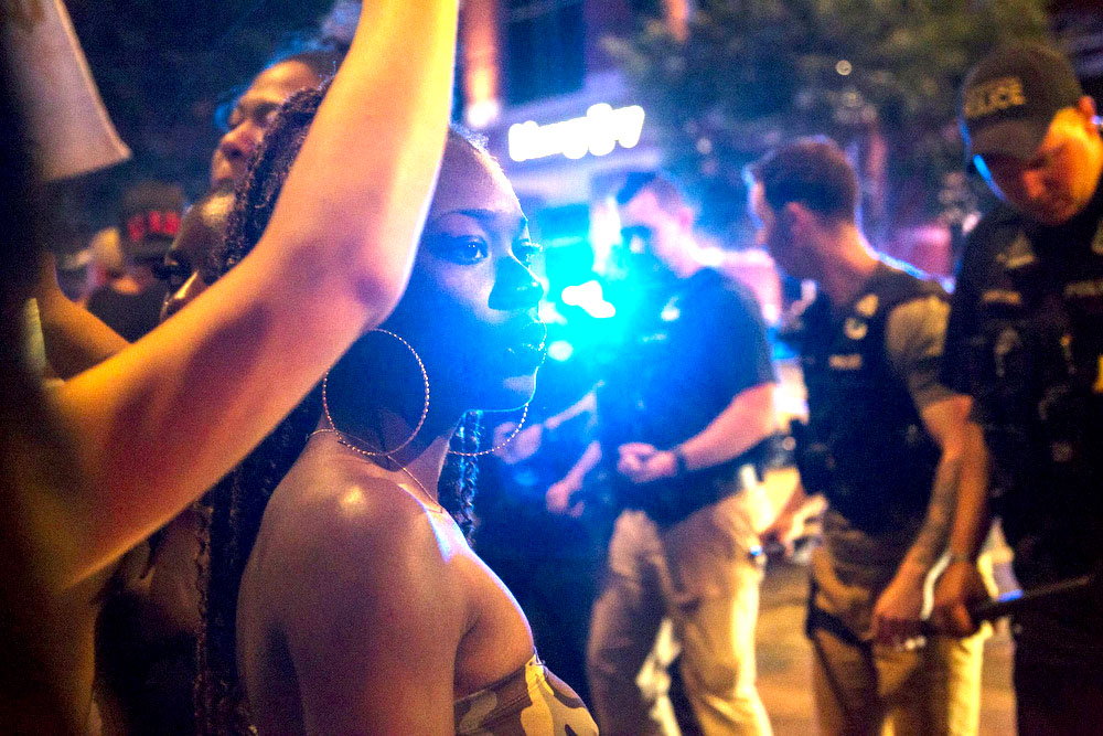 Staff photo by Troy Stolt / Protesters and Chattanooga police line up, Saturday night, on the corner of Frazier Avenue and Tremont Street during protests over the murder of George Floyd by Minneapolis police officers.