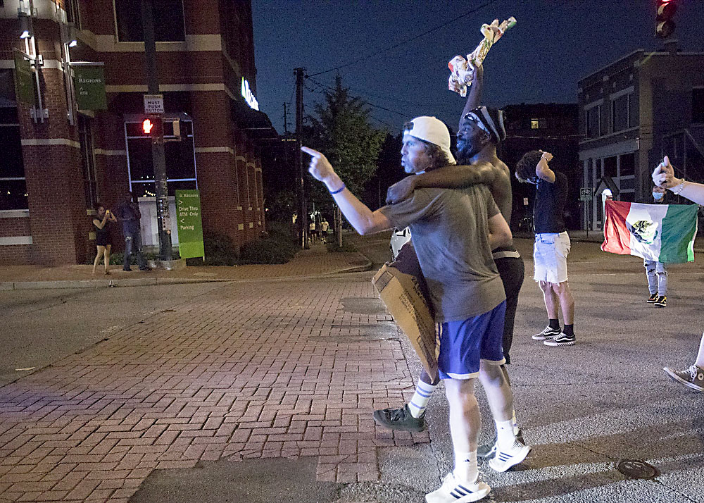 Staff photo by Troy Stolt / Protesters scream at Chattanooga police officers, Saturday night, while blocking traffic on Frazier Avenue during protests over the murder of George Floyd by Minneapolis police officers.