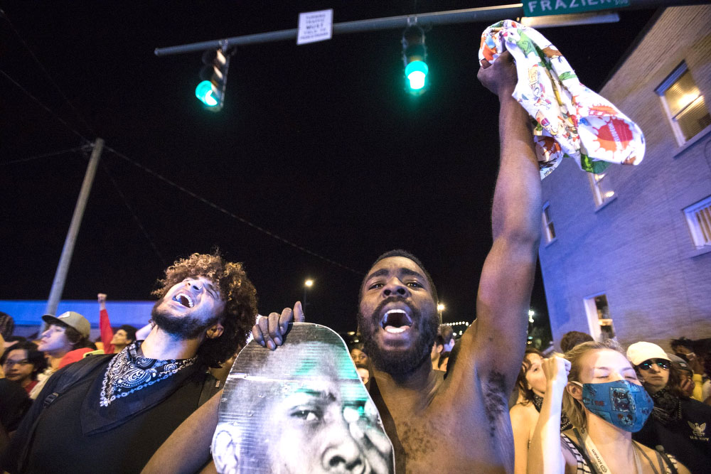 Staff photo by Troy Stolt / Protesters chant after refusing to clear the road, Saturday night, at the corner of Frazier Avenue and Tremont Street during protests over the murder of George Floyd by Minneapolis police officers.