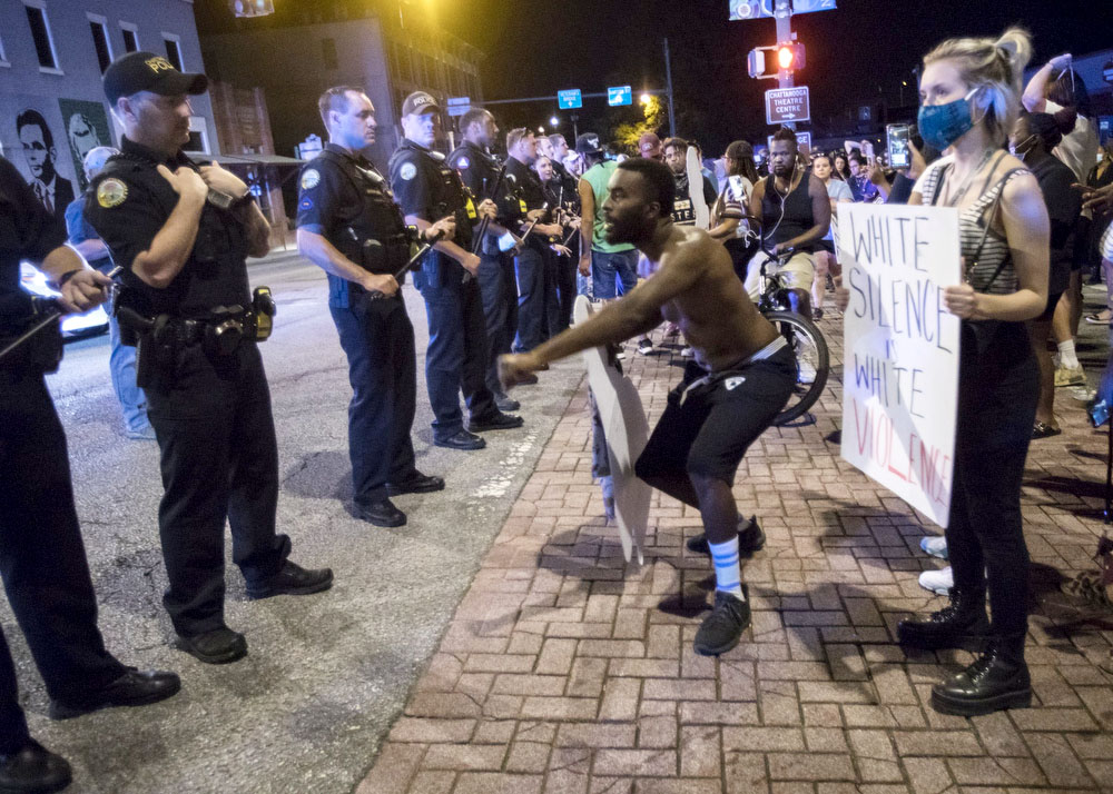 Staff photo by Troy Stolt / A protester engages with Chattanooga Police, Saturday night, on the corner of Frazier Avenue and Tremont Street during protests over the murder of George Floyd by Minneapolis police officers.