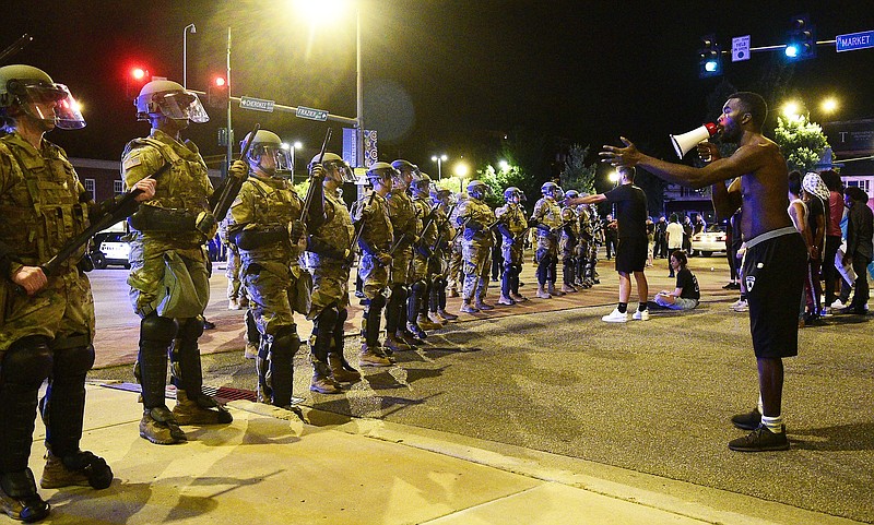 Staff Photo by Robin Rudd / A protester uses a bullhorn as he confronts members of the Tennessee Naitonal Guard. Protests continued for the second night, Sunday, in the waking of the killing of George Floyd in Minneapolis.