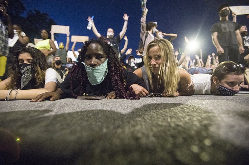 Staff photo by Troy Stolt / Protesters lay down after being tear gassed outside of the old Hamilton County Courthouse on Sunday in Chattanooga, Tenn. Sunday was the second day of protests in Chattanooga over the murder of George Floyd by Minneapolis police officers.