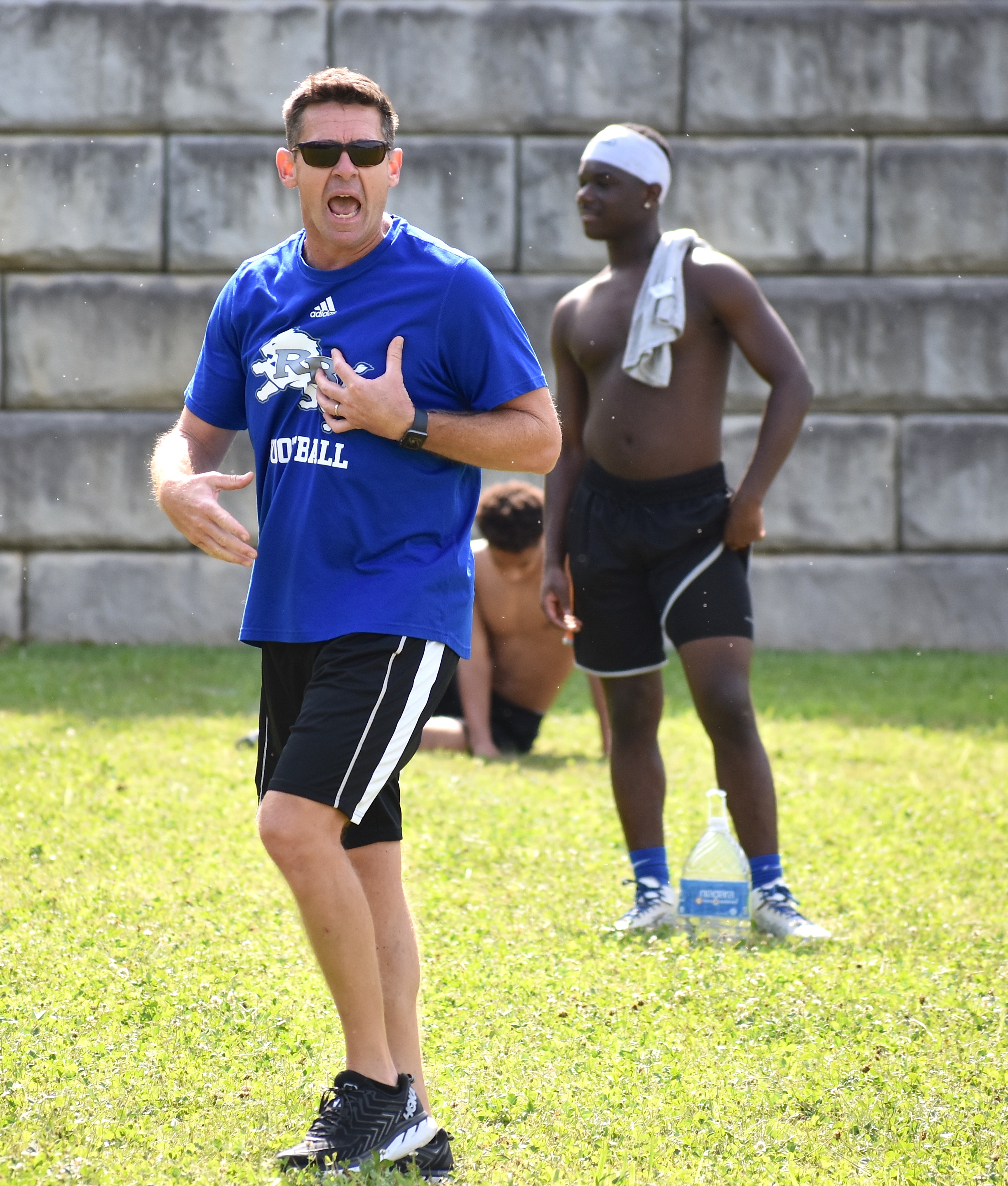 Staff photo by Patrick MacCoon / Red Bank High School defensive coordinator Ted Lockerby shouts instructions to the Lions during a training session Monday.