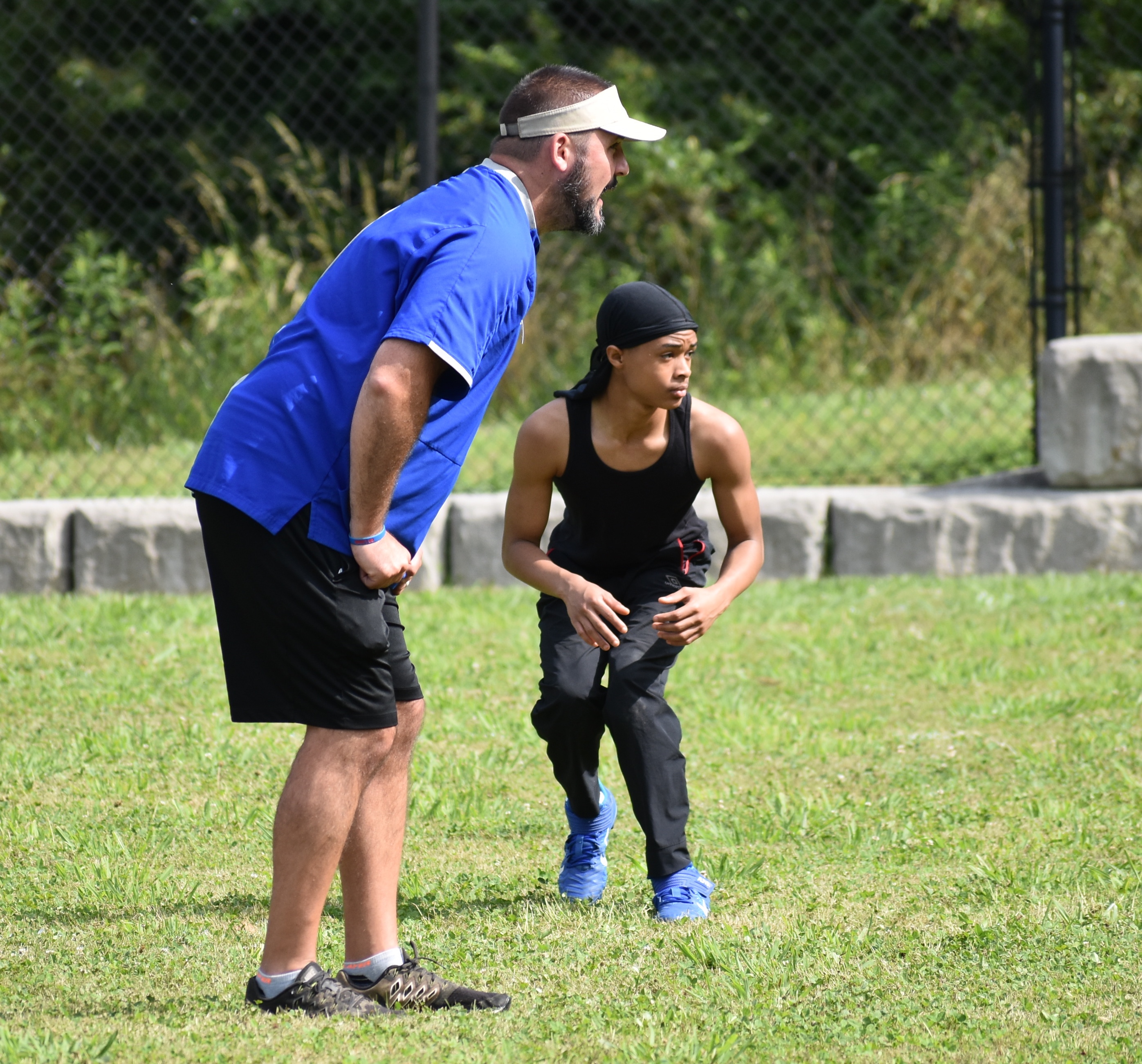 Staff photo by Patrick MacCoon / Red Bank High School football coach Chris Brown works with sophomore Josh Blackmon during a training session Monday.