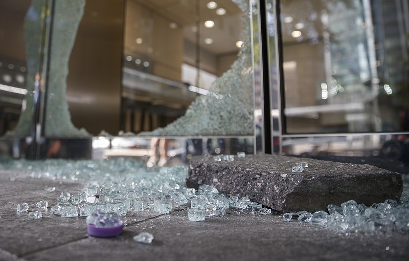 Shattered window and door glass from Mervis Diamond Importers is scattered on sidewalk in Washington, Monday, June 1, 2020, after a night protests over the death of George Floyd. Floyd died after being restrained by Minneapolis police officers on May 25. (AP Photo/Carolyn Kaster)


