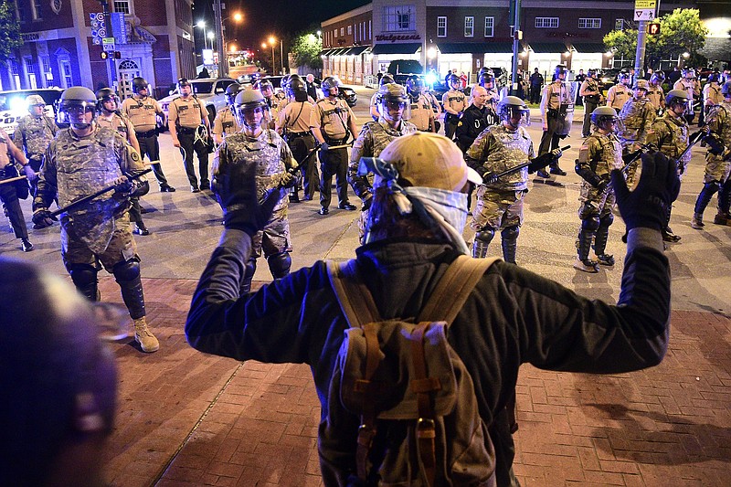 Staff Photo by Robin Rudd / Dressed in riot gear members of the Tennessee National Guard, supported by officers from the Tennessee Highway Patrol, confront protesters at the intersection of North Market Street and Frazier Avenue. Protests continued for the second night, Sunday, in the waking of the killing of George Floyd in Minneapolis.