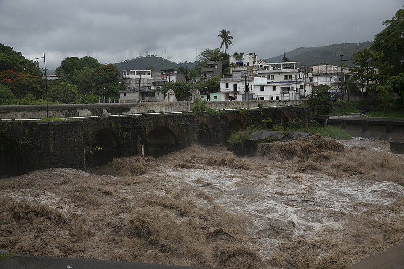 The swollen Los Esclavos River flows violently during tropical storm Amanda in Cuilapa, eastern Guatemala, Sunday, May 31, 2020. The first tropical storm of the Eastern Pacific season drenched parts of Central America on Sunday and officials in El Salvador said at least seven people had died in the flooding. (AP Photo/Moises Castillo)


