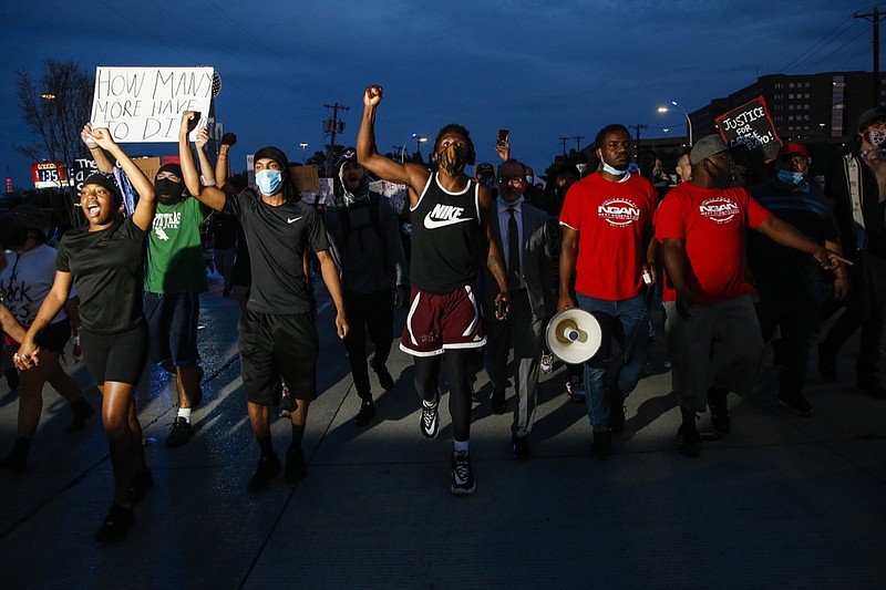 In this June 1, 2020, photo, protesters march to the Margaret Hunt Hill Bridge as they demonstrate against police brutality in Dallas. Protests continue over the death of George Floyd, a black man who died after being restrained by Minneapolis police officers on May 25. (Ryan Michalesko/The Dallas Morning News via AP)