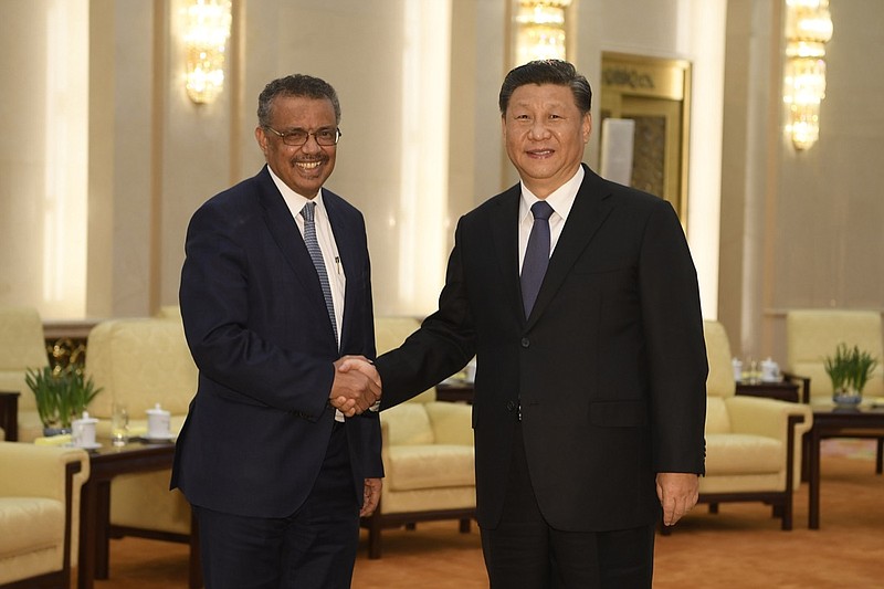 FILE - In this Jan. 28, 2020, file photo, Tedros Adhanom Ghebreyesus, director general of the World Health Organization, left, shakes hands with Chinese President Xi Jinping before a meeting at the Great Hall of the People in Beijing. Throughout January, the World Health Organization publicly praised China for what it called a speedy response to the new coronavirus. It repeatedly thanked the Chinese government for sharing the genetic map of the virus "immediately" and said its work and commitment to transparency were "very impressive, and beyond words." But behind the scenes, there were significant delays by China and considerable frustration among WHO officials over the lack of outbreak data, The Associated Press has found. (Naohiko Hatta/Pool Photo via AP, File)