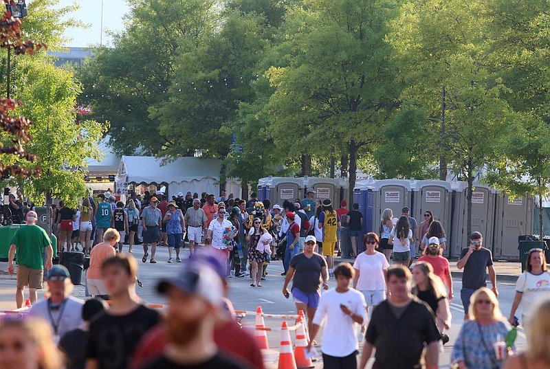Festival-goers walk down Riverfront Parkway during the first night of Riverbend Festival Wednesday, May 29, 2019 in Chattanooga, Tennessee. The attendance of vendors as well as festival-goers was lighter this year than past years. 