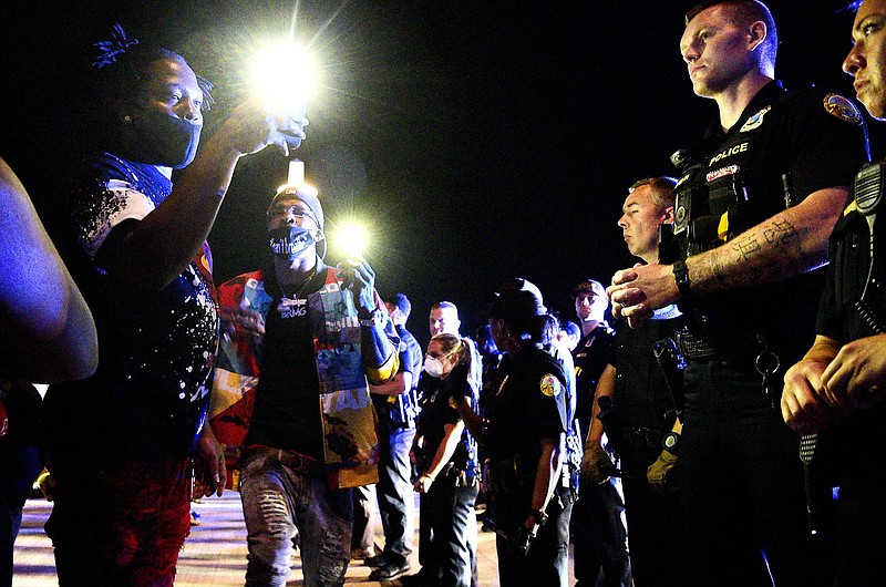 Staff Photo by Robin Rudd / Protesters film Chattanooga Police officers with their phones as their path was blocked on the Market Street Bridge. Protests continued for the second night, Sunday, over the death of George Floyd in Minneapolis.