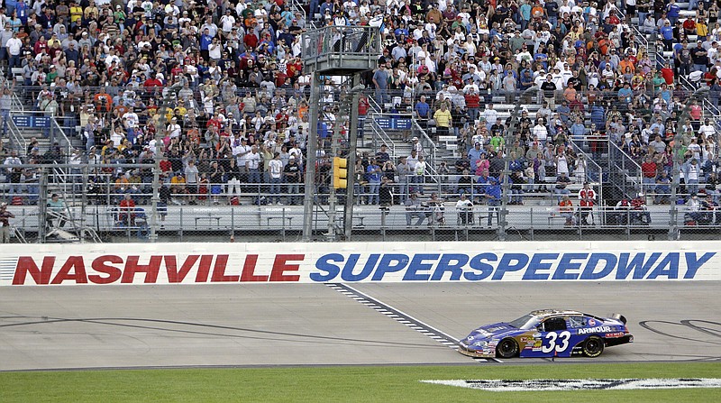 AP photo by Mark Humphrey / NASCAR driver Kevin Harvick takes the checkered flag at the finish line to win the Nashville 300 on April 3, 2010, at Nashville Superspeedway in Gladeville, Tenn. NASCAR is set to return to the track in 2021.