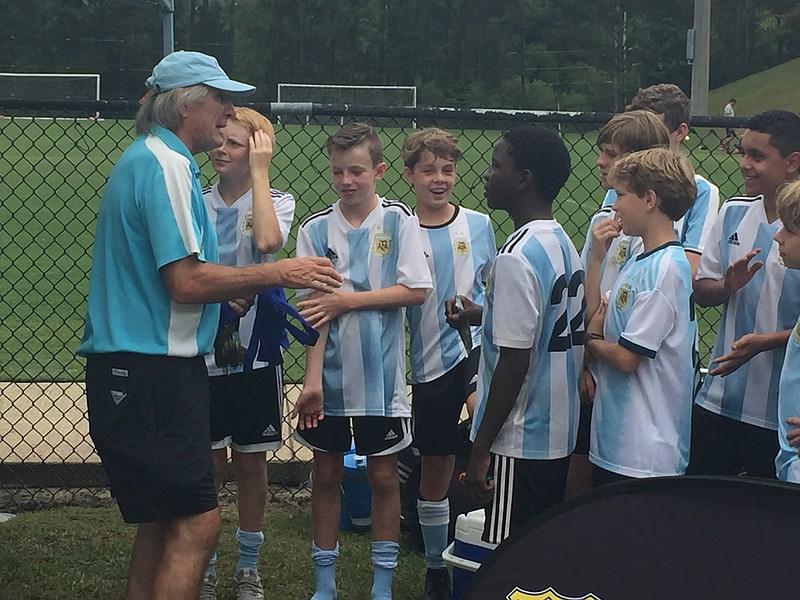 Pedro Kozak hands out medals to his players after a tournament in Birmingham, Alabama, in 2019. / Photo by Mark Kennedy