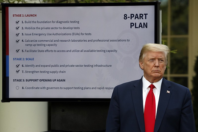 FILE - In this April 27, 2020, file photo, President Donald Trump listens during briefing about the coronavirus in the Rose Garden of the White House in Washington. For weeks, Trump has been eager to publicly turn the page on the coronavirus pandemic. But now the White House fears that the very thing that finally shoved the virus off centerstage — mass protests over the death of George Floyd — may bring about its resurgence. (AP Photo/Alex Brandon, File)