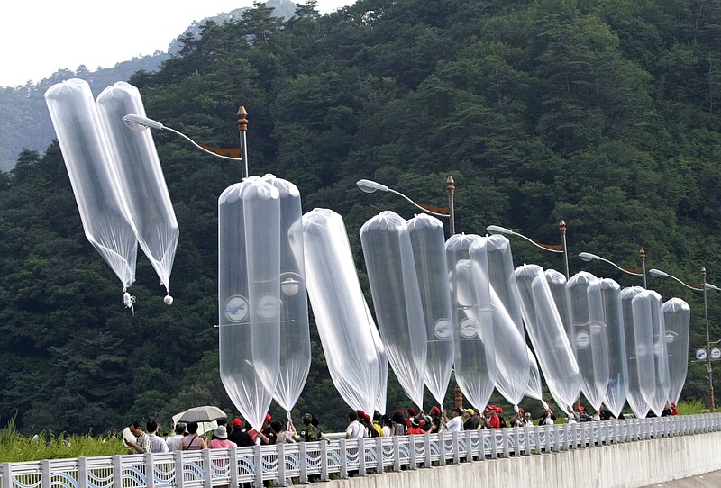 FILE - In this July 29, 2010, file photo, South Korean conservative activists launch balloons carrying leaflets denouncing North Korean leader Kim Jong Il during a rally in Hwacheon, South Korea. South Korea says it plans to push new laws to ban activists from flying anti-Pyongyang leaflets over the border after North Korea threatened to end an inter-Korean military agreement reached in 2018 to reduce tensions if Seoul fails to prevent the protests. (AP Photo/Ahn Young-joon, File)