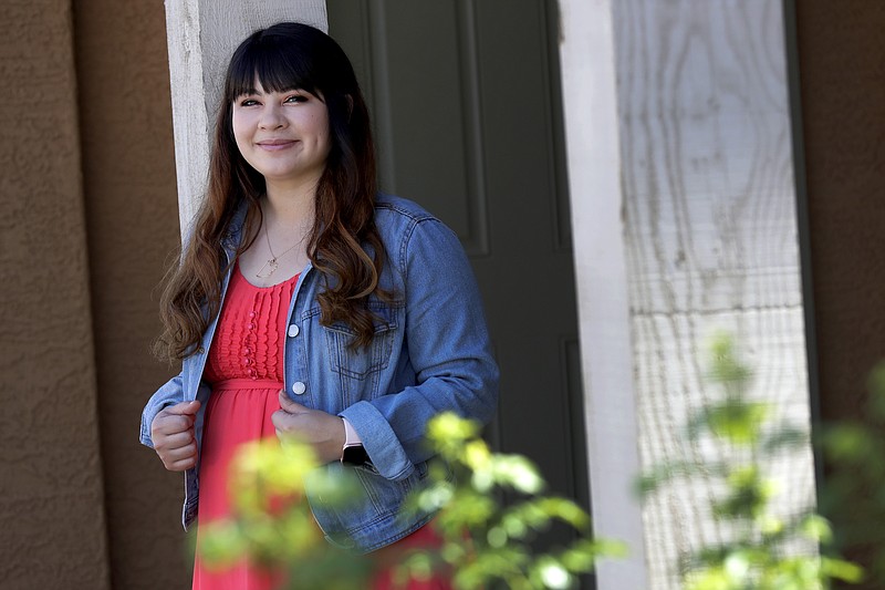 Reyna Montoya stands outside her home Thursday, June 4, 2020, in Gilbert, Ariz. Every Monday, Montoya wakes up extra early and logs onto the Supreme Court's blog, hitting refresh over and over again to find out if it's ruled on the Obama-era program that shields her from deportation. (AP Photo/Matt York)


