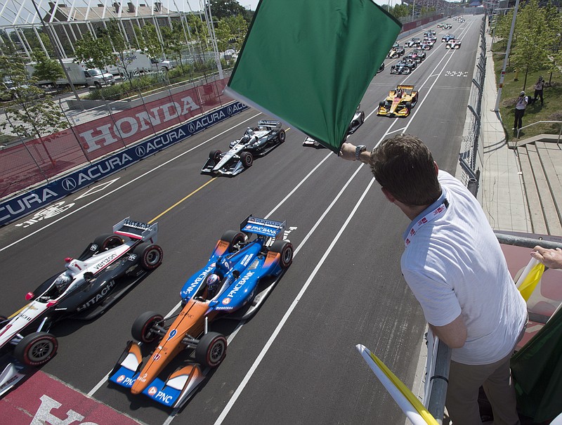 Canadian Press photo by Frank Gunn via AP / Canadian-American actor and racing enthusiast Jason Priestley waves the green flag to start an IndyCar race on July 15, 2018, in Toronto.