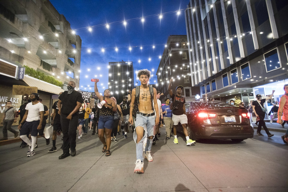 Staff photo by Troy Stolt / Protester Jesse Cowley leads protesters through West Village during a peaceful demonstration on the sixth day of protests over the death of George Floyd on Thursday, June 4, 2020 in Chattanooga, Tenn.