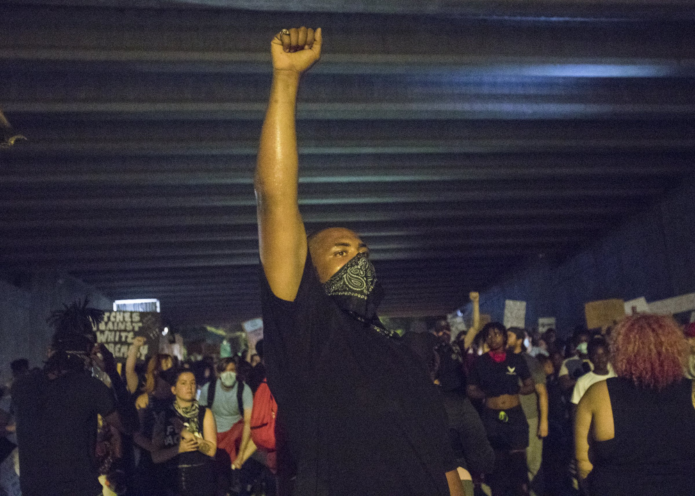 Staff photo by Troy Stolt / Protester Devin Guy raises his fist during a peaceful demonstration on the sixth day of protests over the death of George Floyd on Thursday, June 4, 2020 in Chattanooga, Tenn.