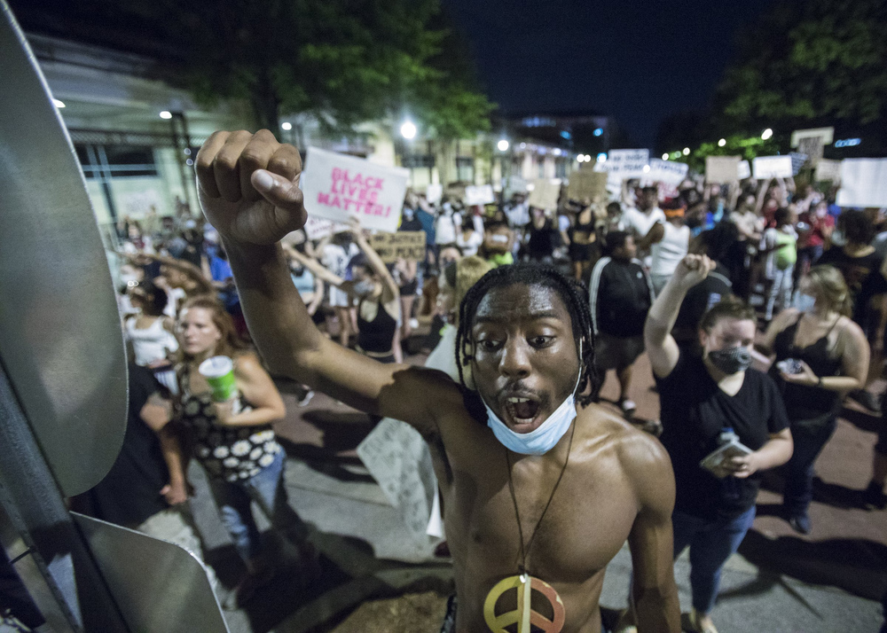 Staff photo by Troy Stolt / Protester Joseph Gallimore chants while marching past the Chattanooga Convention Center during a peaceful demonstration on the sixth day of protests over the death of George Floyd on Thursday, June 4, 2020 in Chattanooga, Tenn.