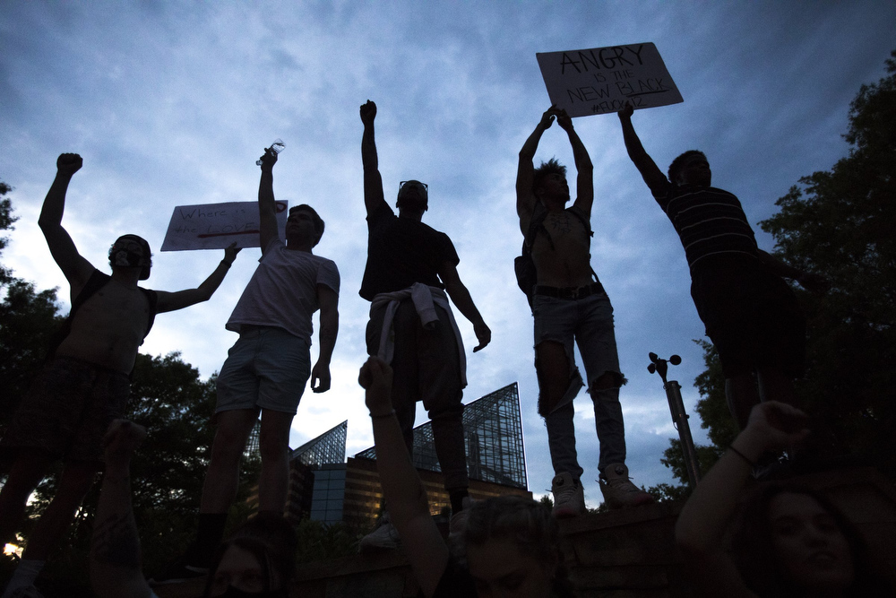 Staff photo by Troy Stolt / Protesters raise their fists in front of the Tennessee Aquarium during a peaceful demonstration on the sixth day of protests over the death of George Floyd on Thursday, June 4, 2020 in Chattanooga, Tenn.