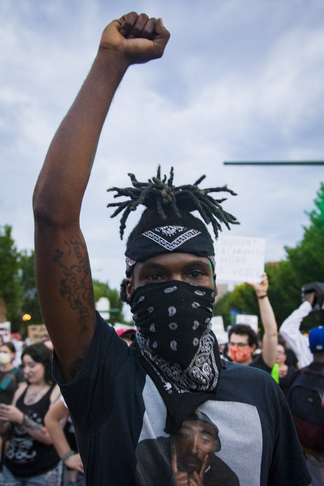 Staff photo by Troy Stolt / Protester Nicolas Moore marches down Market Street during a peaceful demonstration on the sixth day of protests over the death of George Floyd on Thursday, June 4, 2020 in Chattanooga, Tenn.