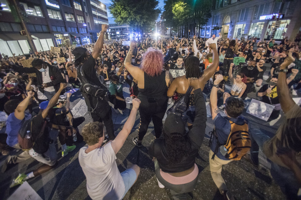 Staff photo by Troy Stolt / Protesters take a moment of silence as they kneel on Broad Street during a peaceful demonstration on the sixth day of protests over the death of George Floyd on Thursday, June 4, 2020 in Chattanooga, Tenn. The protests, which remained peaceful, took place hours after it was reported that the Chattanooga Police Department had arrested a drunk man holding an AK-47 on a Market Street rooftop the night before who had intended to defend himself "in the event the protest turned violent and people came burn his building or kill him," court records state.