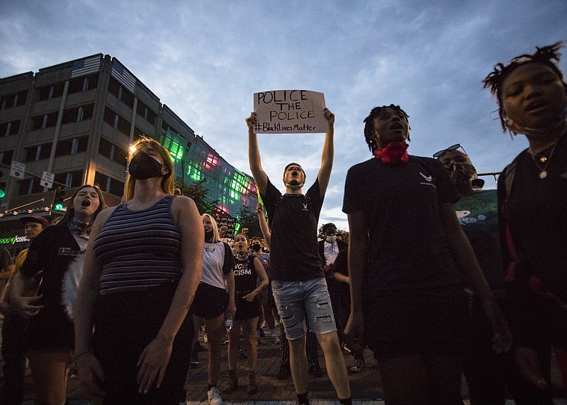 Staff photo by Troy Stolt / Protesters stop at an intersection on Broad Street during a peaceful demonstration on the sixth day of protests over the death of George Floyd on Thursday, June 4, 2020 in Chattanooga, Tenn.
