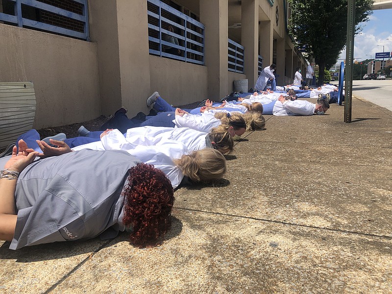 Staff photo by Elizabeth Fite / Medical students and physicians lined the sidewalk in the heart of Chattanooga's medical corridor for nine minutes of silence on Friday, June 5, 2020, in a show of solidarity against racial injustice in the wake of national protests over the death of George Floyd.