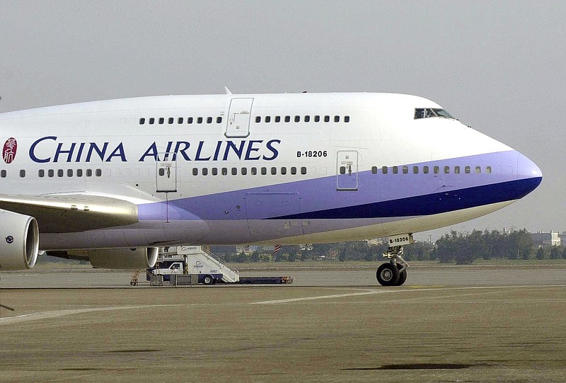FILE - In this Jan. 26, 2003, file photo, a China Airlines Boeing 747-400 sits on the tarmac at the Chiang Kai-shek International airport in Taoyuan, Taiwan. The Trump administration on Friday, June 5, 2020, is backing away from a threat to ban all flights to the U.S. by Chinese airlines. It will allow Chinese carriers to operate a total of two flights a week between the two countries.(AP Photo/Jerome Favre, File)