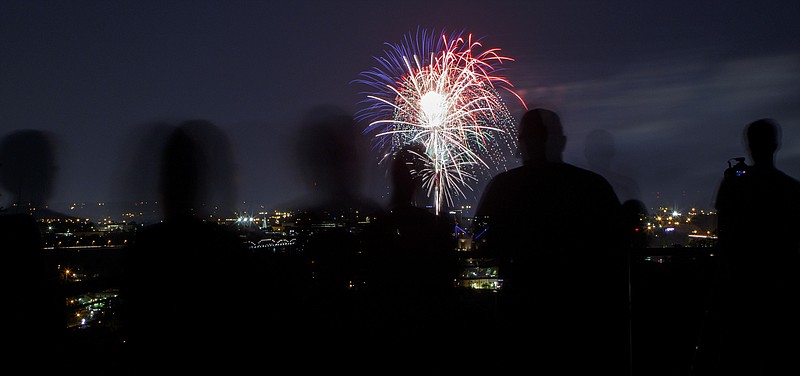 Staff file photo by C.B. Schmelter / People watch from the Stringer's Ridge Park overlook as fireworks from the 2018 Pops on the River Independence Day celebration light up the sky over the Tennessee River. This year's event has been canceled.
