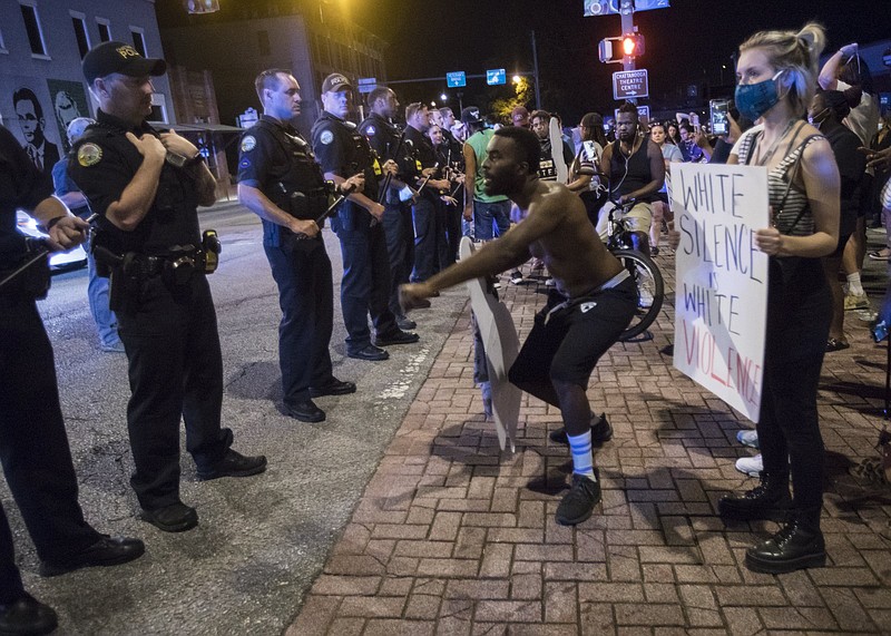Staff photo by Troy Stolt / A protester engages with Chattanooga Police on the corner of Frazier Avenue and Tremont Street during protests over the murder of George Floyd by Minneapolis police officers on Saturday, May 30, 2020 in Chattanooga, Tenn.