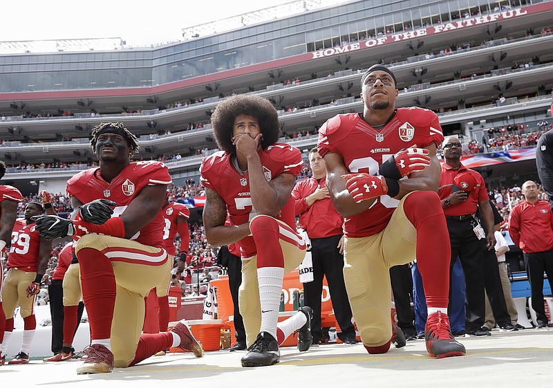AP photo by Jose Marcio Sanchez / From left, San Francisco 49ers outside linebacker Eli Harold, quarterback Colin Kaepernick and safety Eric Reid kneel during the national anthem before a game against the Dallas Cowboys on Oct. 2, 2016, in Santa Clara, Calif. Kaepernick hasn't played in the NFL since that season, but in recent days many associated with the league have expressed support for the stance Kaepernick took by kneeling.
