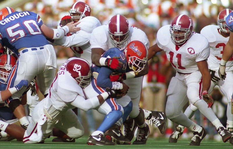 Alabama photo by Kent Gidley / Alabama inside linebacker Michael Rogers (52), defensive end John Copeland (94) and outside linebacker Lemanski Hall (11) converge on Florida running back Errict Rhett during the early stages of the Crimson Tide's 28-21 win over the Gators in the 1992 SEC championship game at Birmingham's Legion Field.