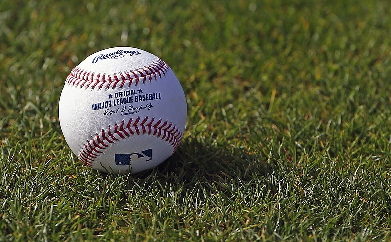 AP photo by Ross D. Franklin / A baseball is shown on the grass on Feb. 17, 2017, at the Cincinnati Reds' spring training facility in Goodyear, Ariz.