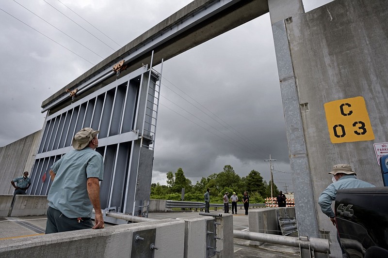 Crews from the Southeast Louisiana Flood Protection Authority East close the Bayou Road flood gate in St. Bernard Parish, La. Saturday, June 6, 2020, ahead of Tropical Storm Cristobal. A re-energized Tropical Storm Cristobal advanced toward the U.S. Gulf Coast early Saturday, bringing with it the heavy rains that already caused flooding and mudslides in Mexico and Central America. (Max Becherer/The Times-Picayune/The New Orleans Advocate)

