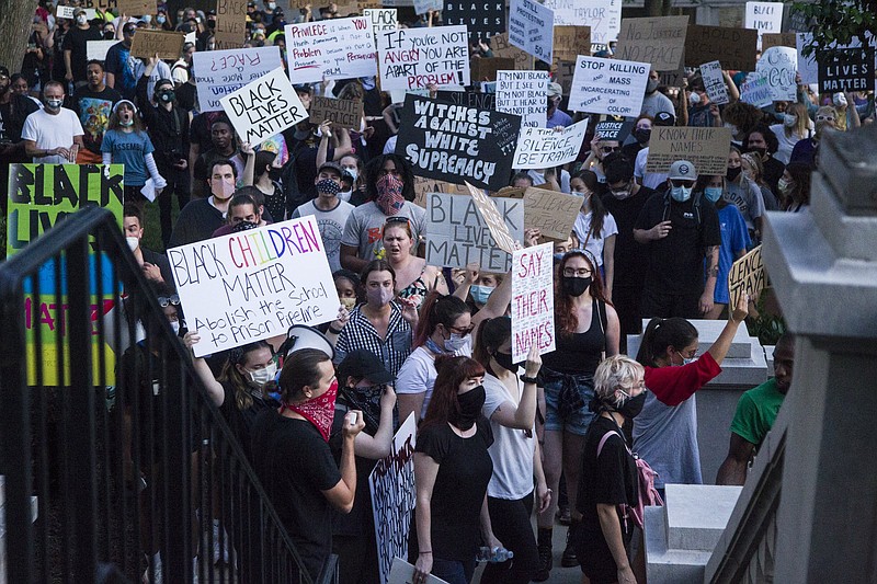 Staff photo by Troy Stolt / Protesters march past the old Hamilton County Courthouse during protests over police brutality after George Floyd was killed by Minneapolis police on June 5, 2020, in Chattanooga.