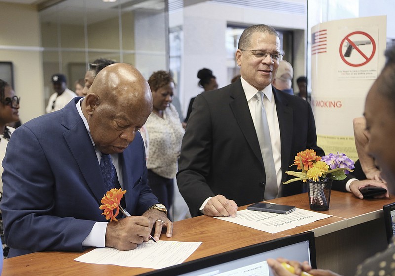 FILE - In this Oct. 17, 2016 file photo, Congressman John Lewis, left, and Fulton County Chairman John Eaves sign in to vote on the first day of early voting in Atlanta. Eaves is running in the Georgia's 7th Congressional District. (Bob Andres/Atlanta Journal-Constitution via AP)