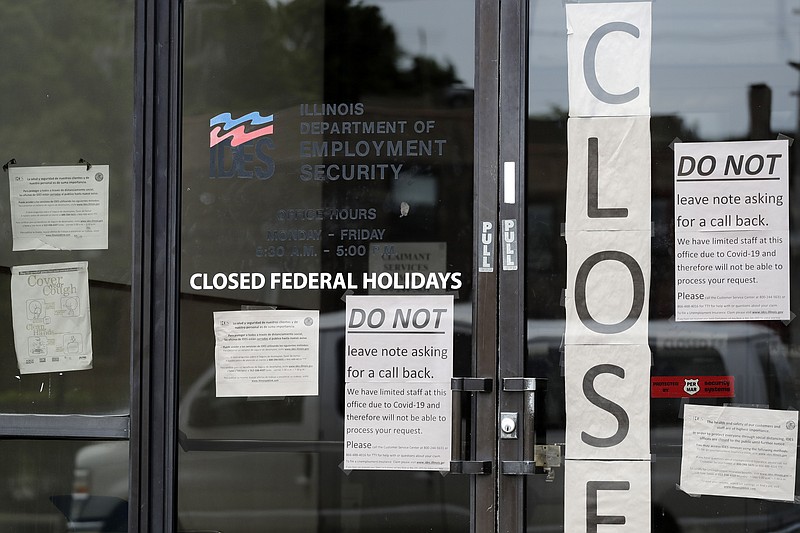 Information signs are posted at the Illinois Department of Employment Security Friday, June 5, 2020, in Chicago. The federal unemployment rate declined to 13.3 percent in May from 14.7 percent in April with a gain of 2.5 million jobs. (AP Photo/Nam Y. Huh)