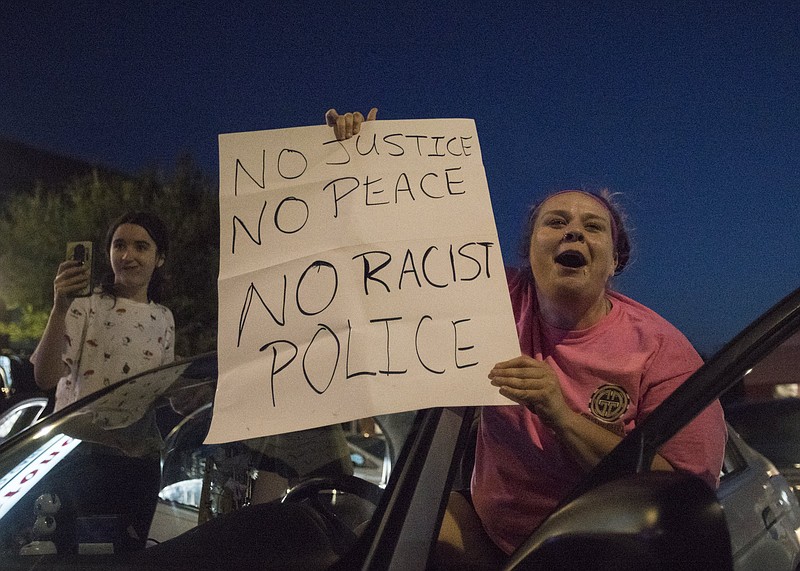 Staff photo by Troy Stolt / Two motorists cheer on a crowd of protesters as they march down Market Street during the third day of protests on Monday, June 1, 2020, in Chattanooga, Tenn., over the death of George Floyd under the knee of a Minneapolis police officer. 
