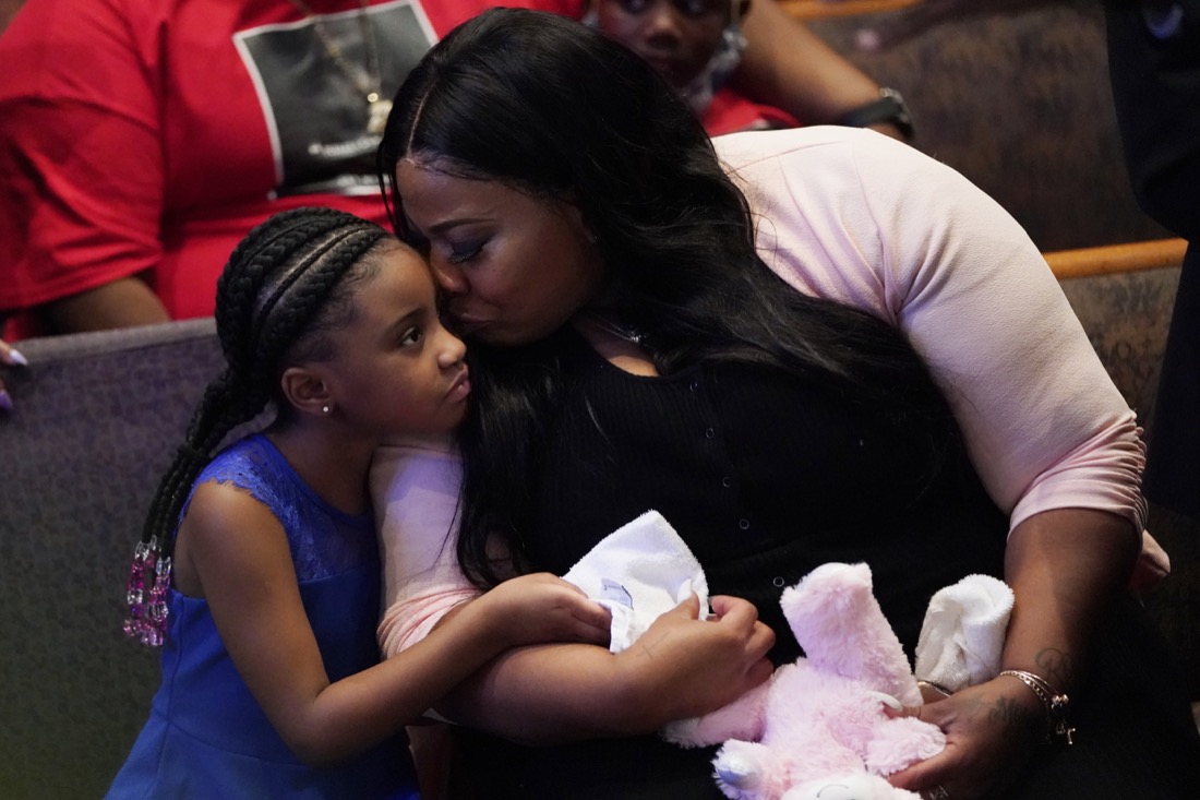 Roxie Washington holds Gianna Floyd, the daughter of George Floyd as they attend the funeral service for George Floyd at The Fountain of Praise church Tuesday, June 9, 2020, in Houston. (AP Photo/David J. Phillip, Pool)