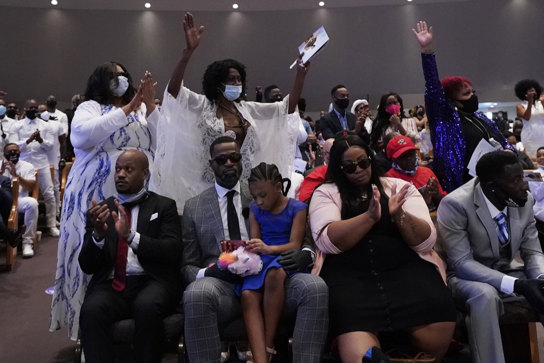 Sister of George Floyd, Zsa Zsa Floyd, both arms raised, attend the funeral service for Floyd at The Fountain of Praise church Tuesday, June 9, 2020, in Houston. (AP Photo/David J. Phillip, Pool)